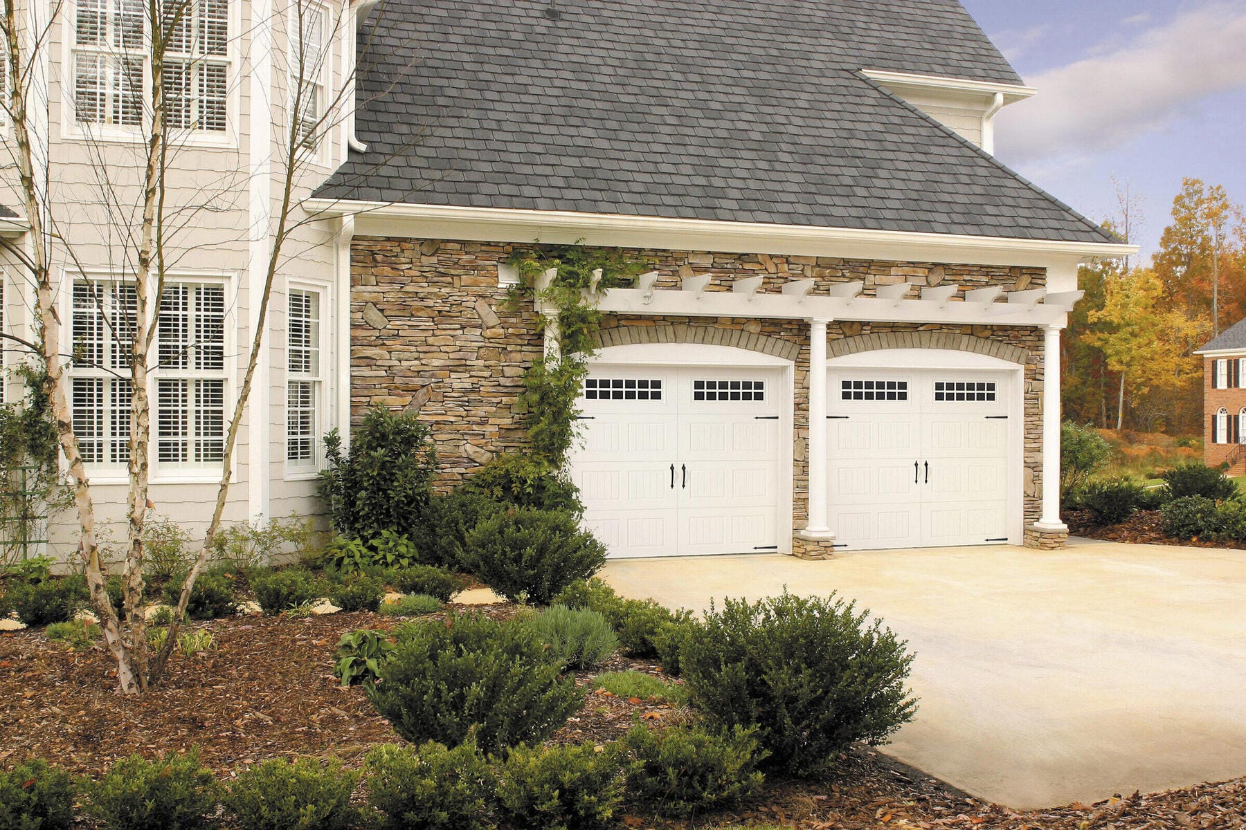 Beautiful home with upgraded carriage house garage doors and stone facade