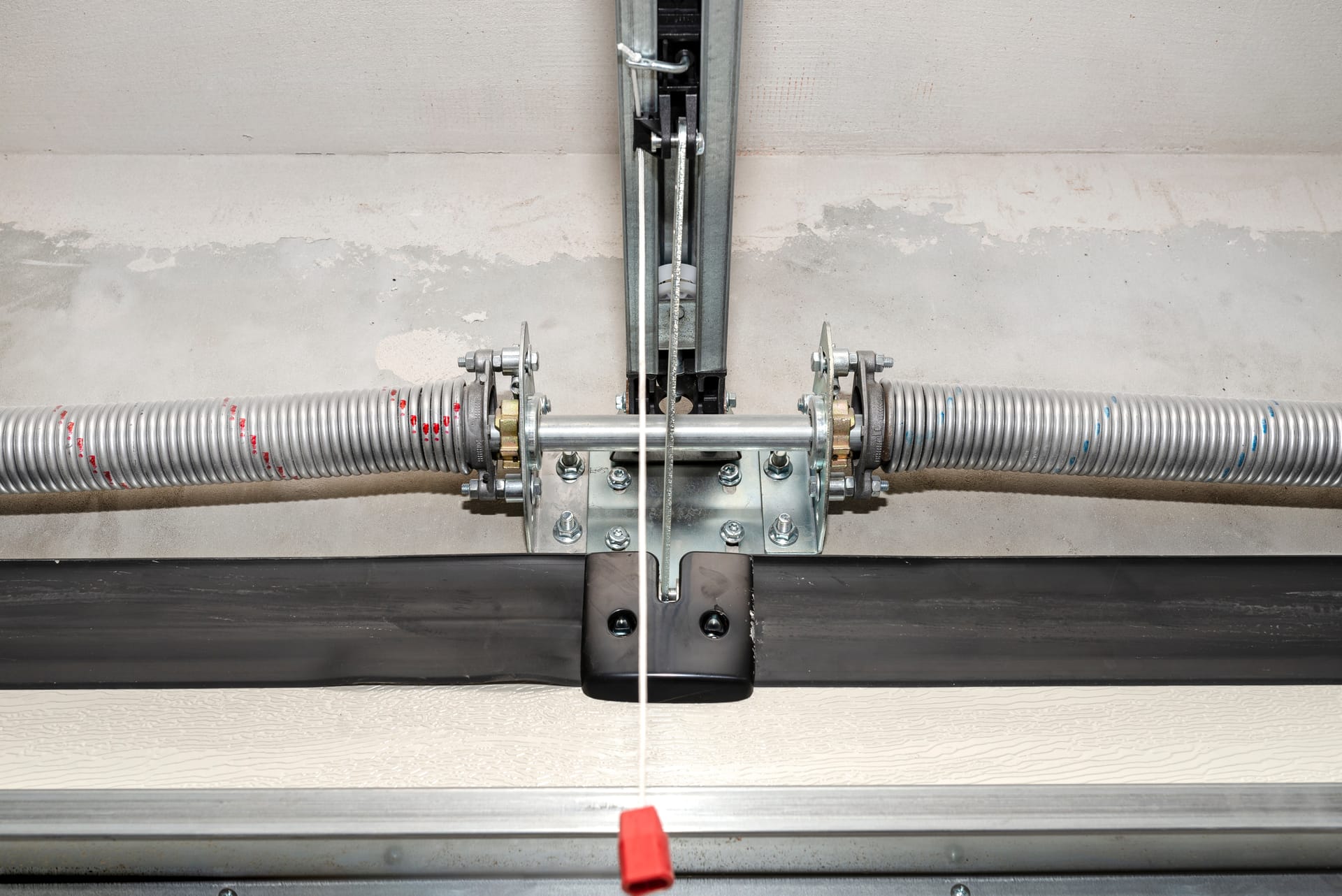 Torsion spring assembly mounted on garage door shaft