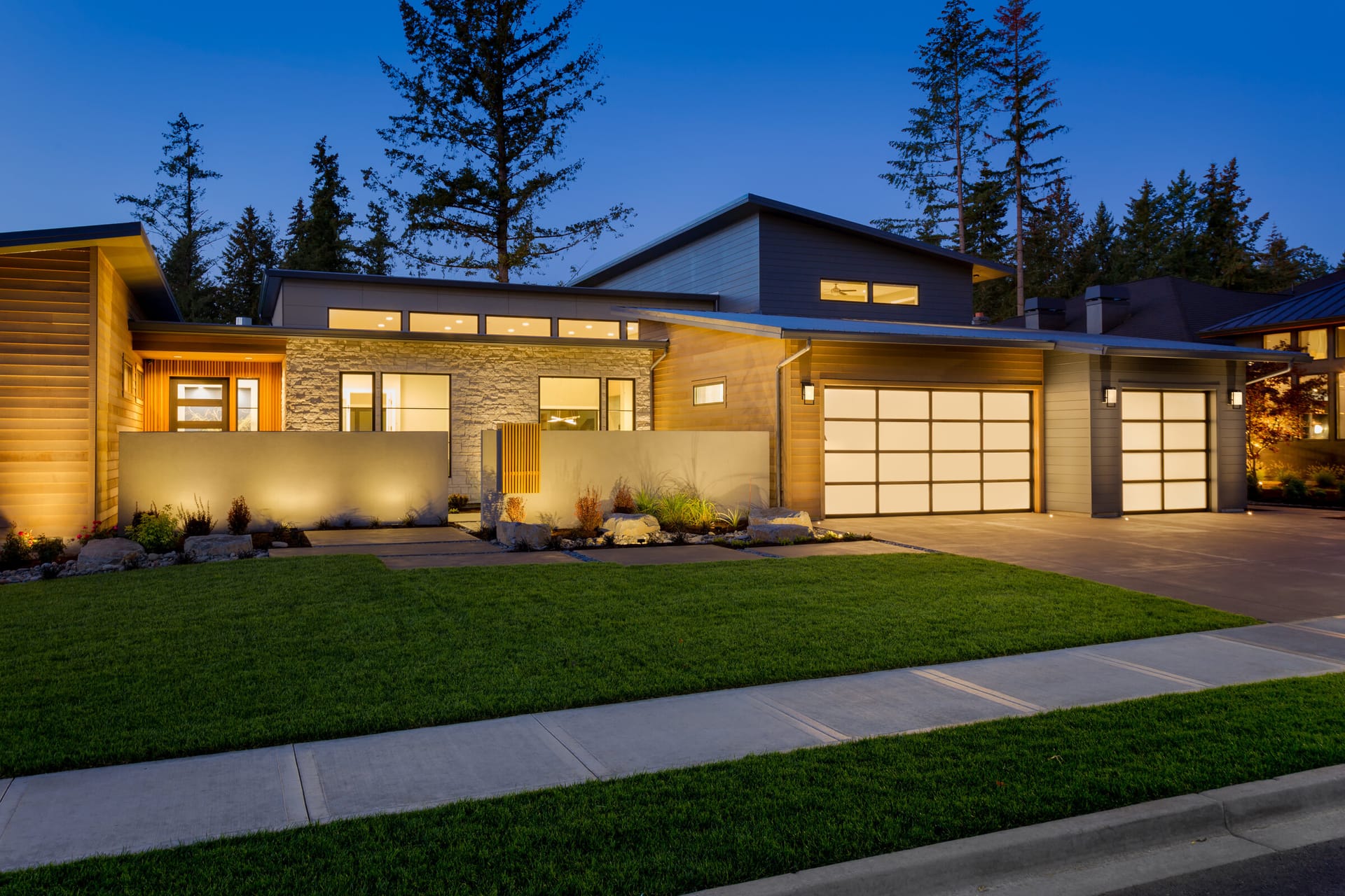Beautiful home with garage doors at twilight